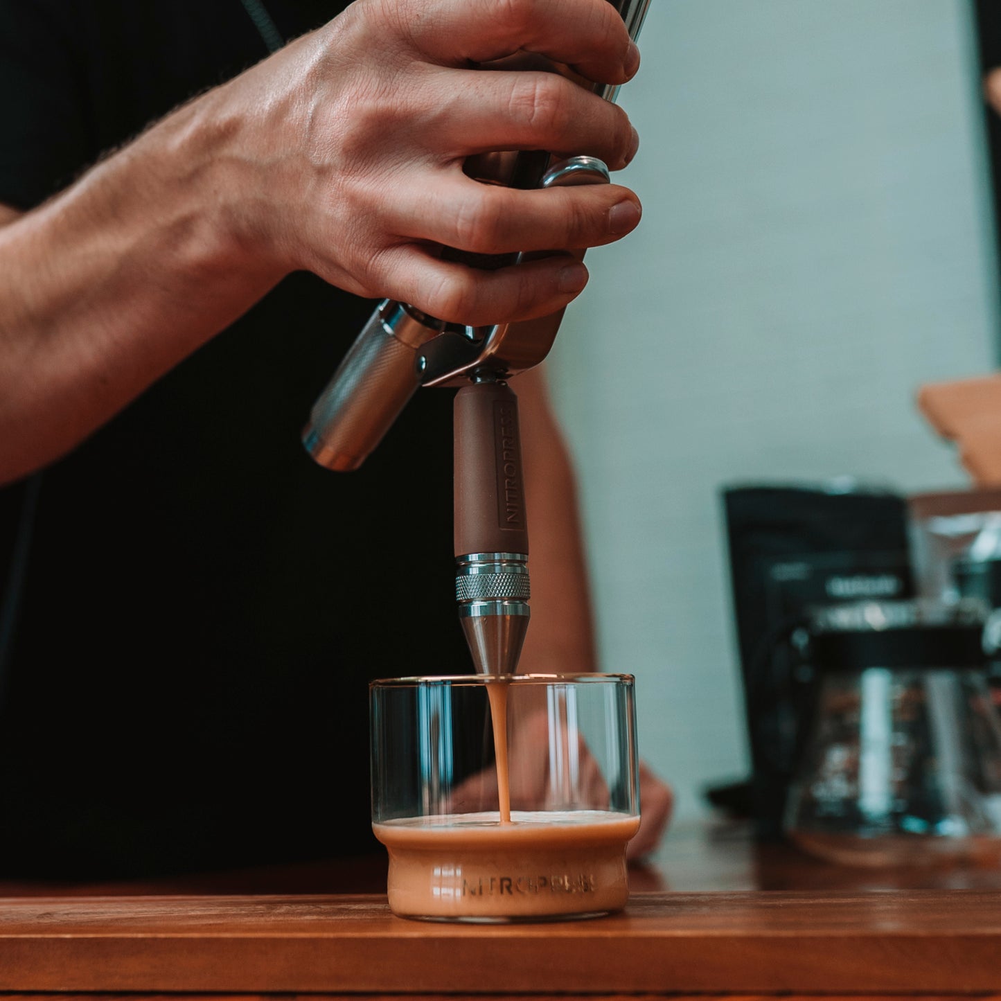 Barista serving nitro in a coffee shop